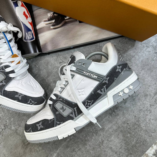 Black and white LV lace-up trainers with logo patch, side panel print, and padded tongue