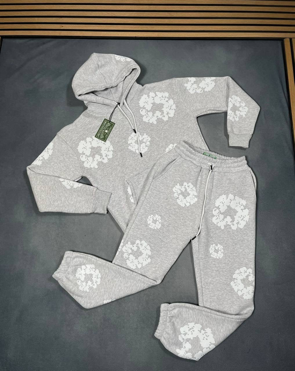 Grey hoodie and jogger tracksuit set with white floral logo pattern