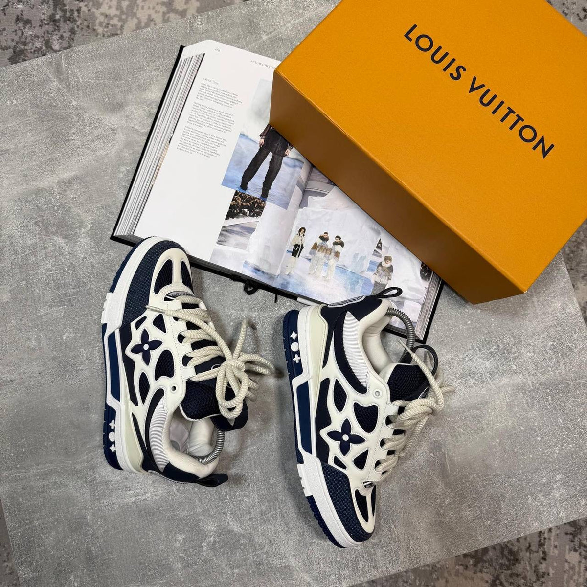 Navy-and-cream skate sneakers with logo flower emblems, white laces, chunky sole