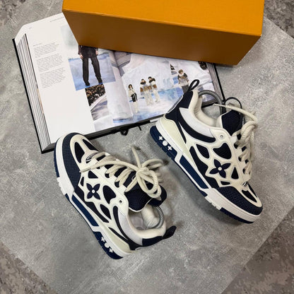 Navy-and-cream skate sneakers with white laces, logo flower emblems, chunky sole