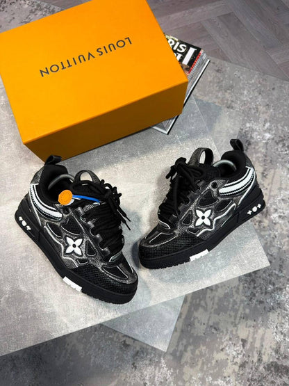 Black skate sneakers with black laces and white logo flower patches, chunky sole