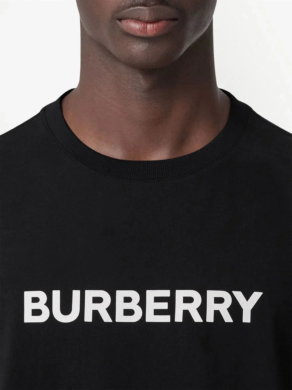 Close-up: black Harriston T-shirt with 'BURBERRY' logo print across chest