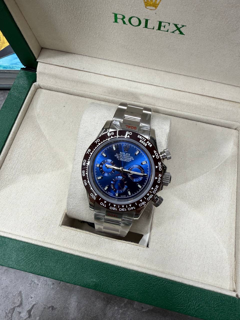 Rolex dark blue dial chronograph watch with silver metal bracelet in box