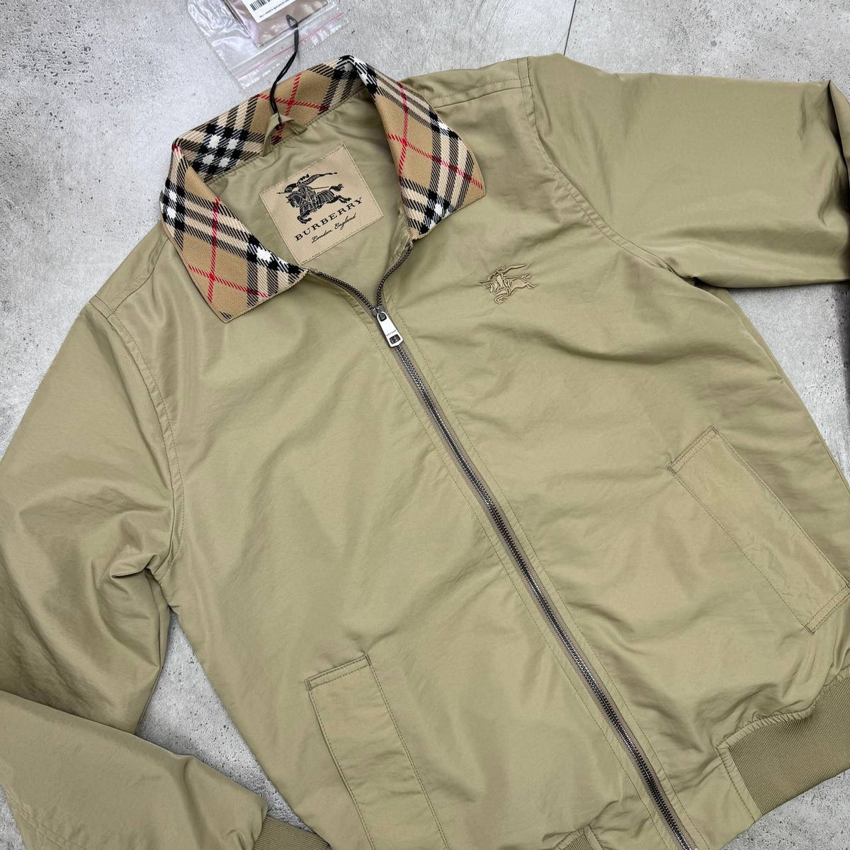 Beige Harrington jacket, front zip with welt pockets and Burberry check inner collar