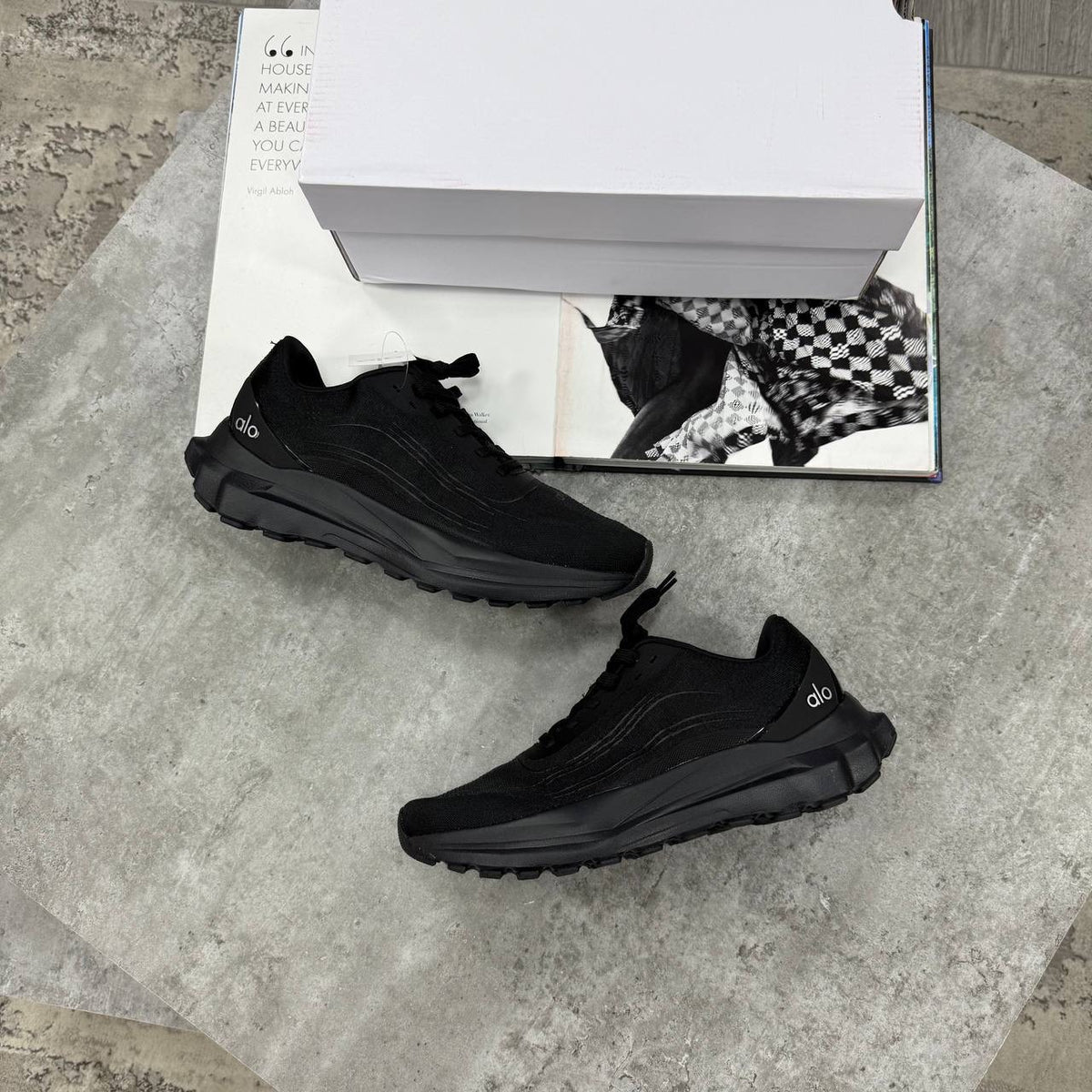 Black lace-up training sneakers with textured upper and chunky treaded sole