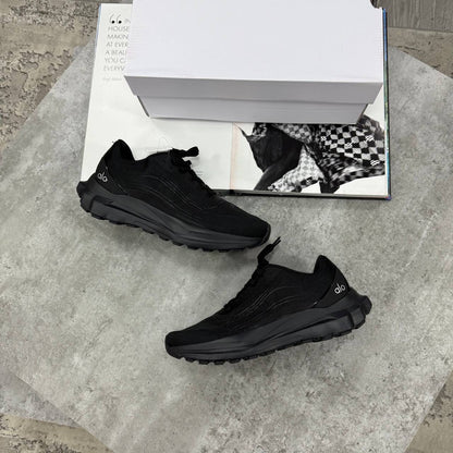 Black lace-up training sneakers with textured upper and chunky treaded sole