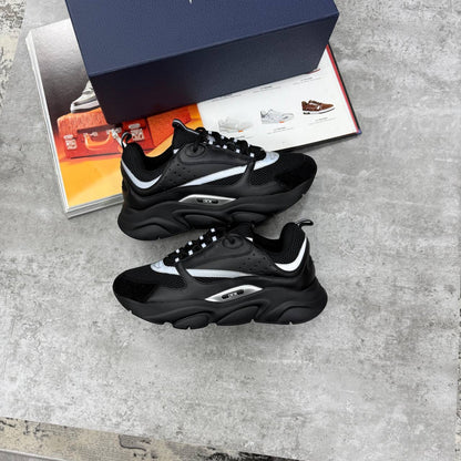 Black low-top trainers with chunky white sole, lace-up, sporty panel design