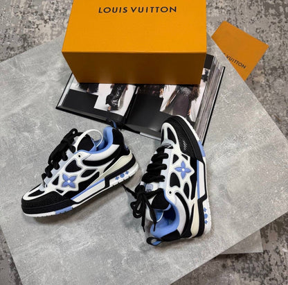 LV skates sneakers pair, black laces, white uppers with blue star panels, chunky sole
