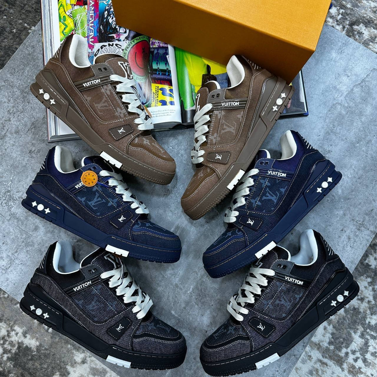 Multicolour LV trainers set: brown, navy, and black pairs with monogram panels.
