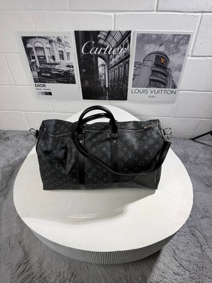 LV monogram carry bag with structured shape, metal zipper pulls, side straps