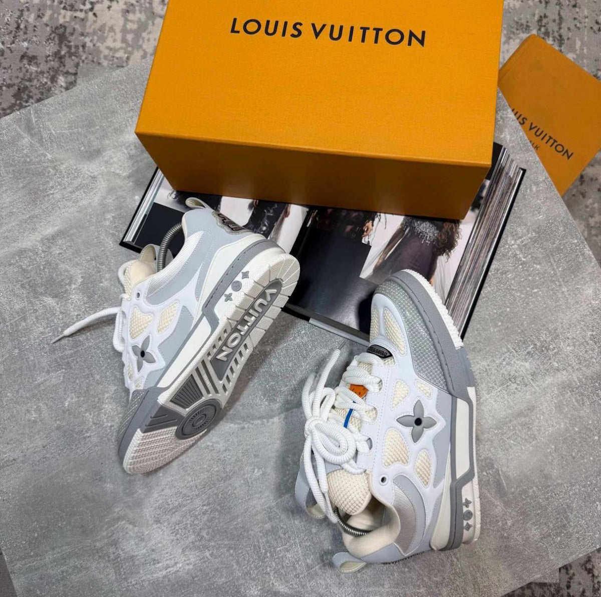 White skate sneakers with gray sole, beige laces, logo flower emblems and tread
