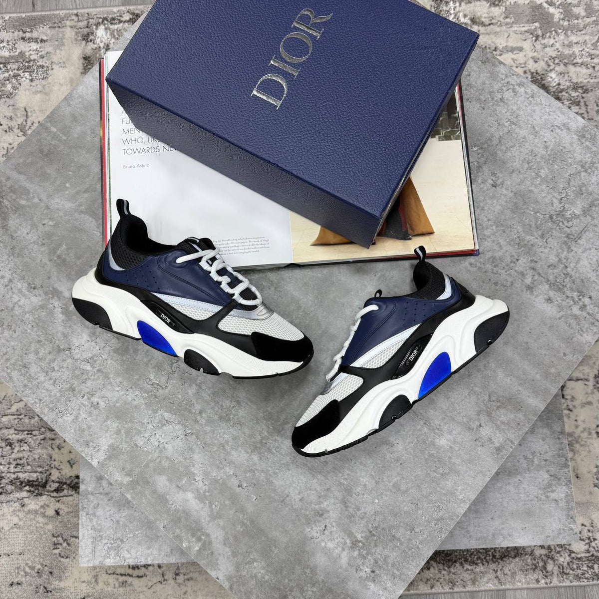 Navy and blue low-top trainers with chunky white sole, lace-up and mesh panels