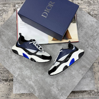 Navy and blue low-top trainers with chunky white sole, lace-up and mesh panels