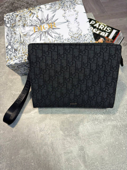 Black Oblique monogram pouch with top zipper and short wrist strap