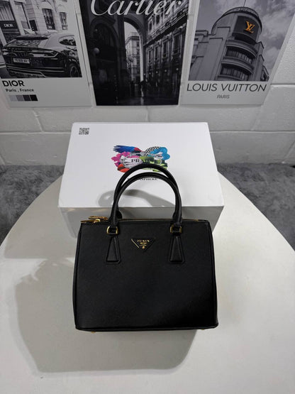 Black LV Alma BB-style handbag front view with gold-tone emblem and handles