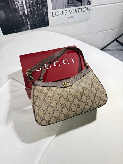 GG brown canvas handbag with red band and gold-tone clasp, top handle