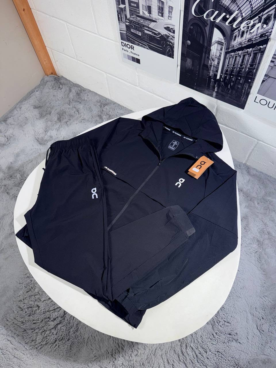Hooded zip tracksuit jacket in navy with logo patch and orange tag
