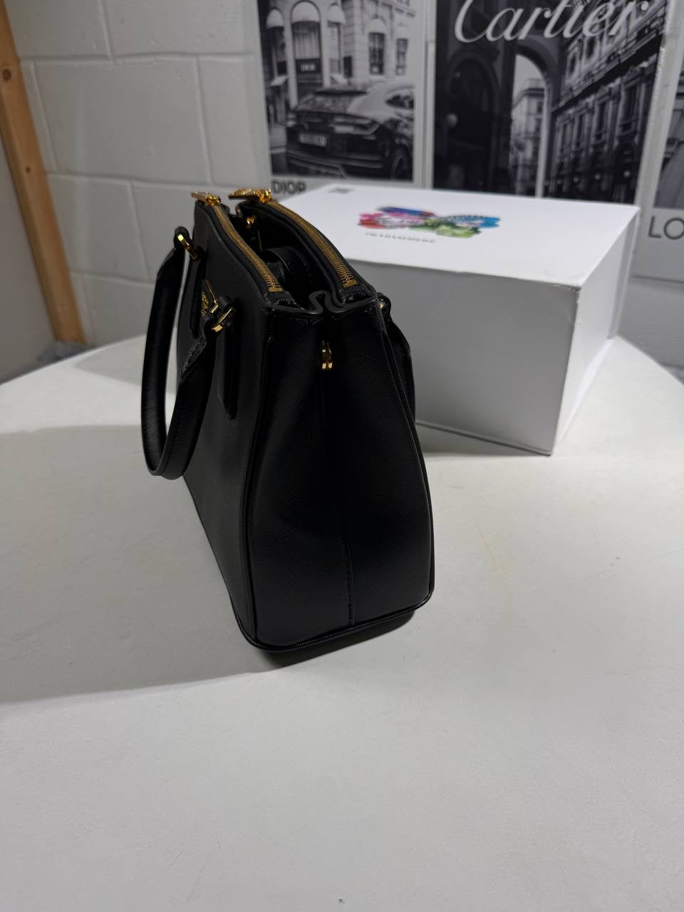 Black LV Alma BB-style crossbody bag front view with gold-tone LV emblem