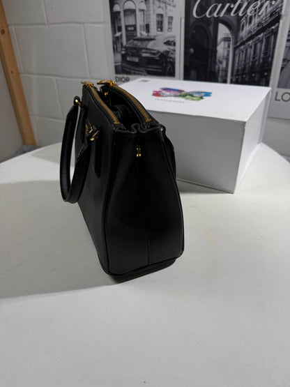 Black LV Alma BB-style crossbody bag front view with gold-tone LV emblem