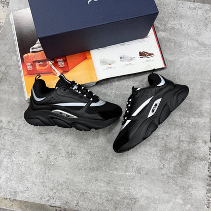 Black low-top trainers with chunky white sole, lace-up, contrast side stripe details
