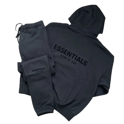 Dark tracksuit set with zip hoodie and joggers, ESSENTIALS logo on chest