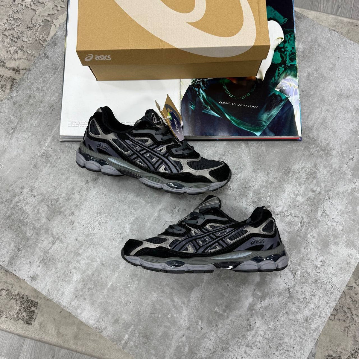 ASICS running shoes in black with gray pattern details and dark rubber outsole