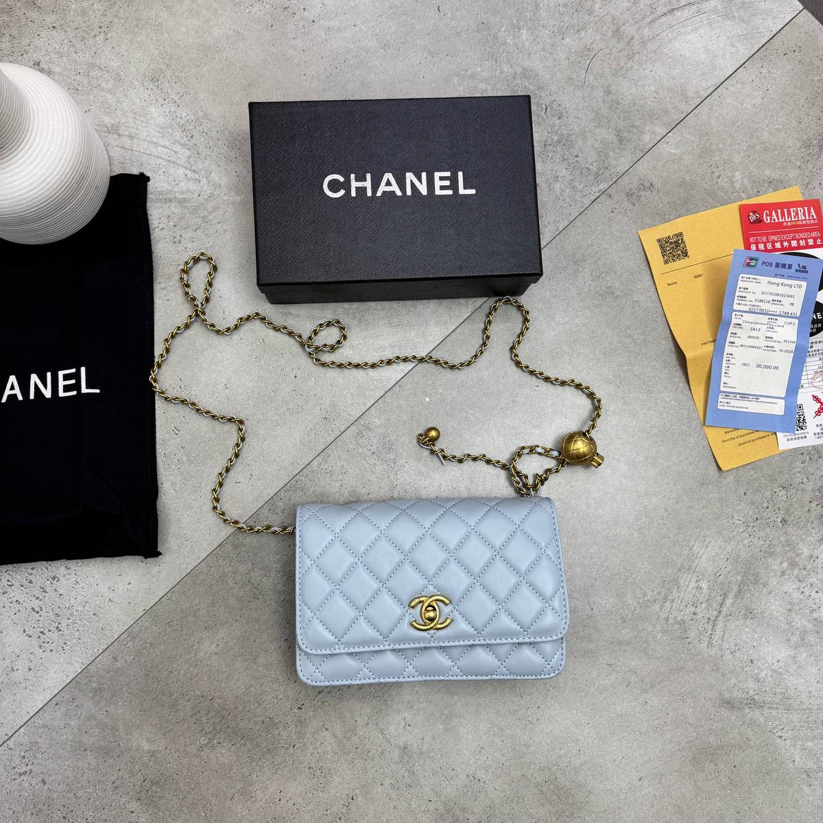 Light blue quilted shoulder bag with gold chain strap and logo CC clasp on flap