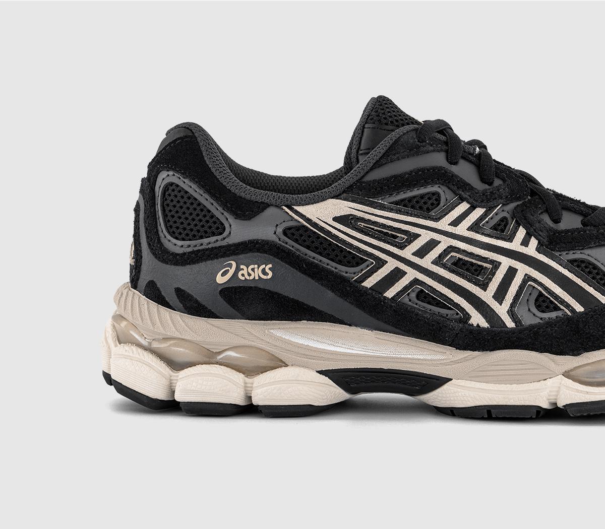 Close-up of black sneakers with cream Asics stripes and textured quarter panels