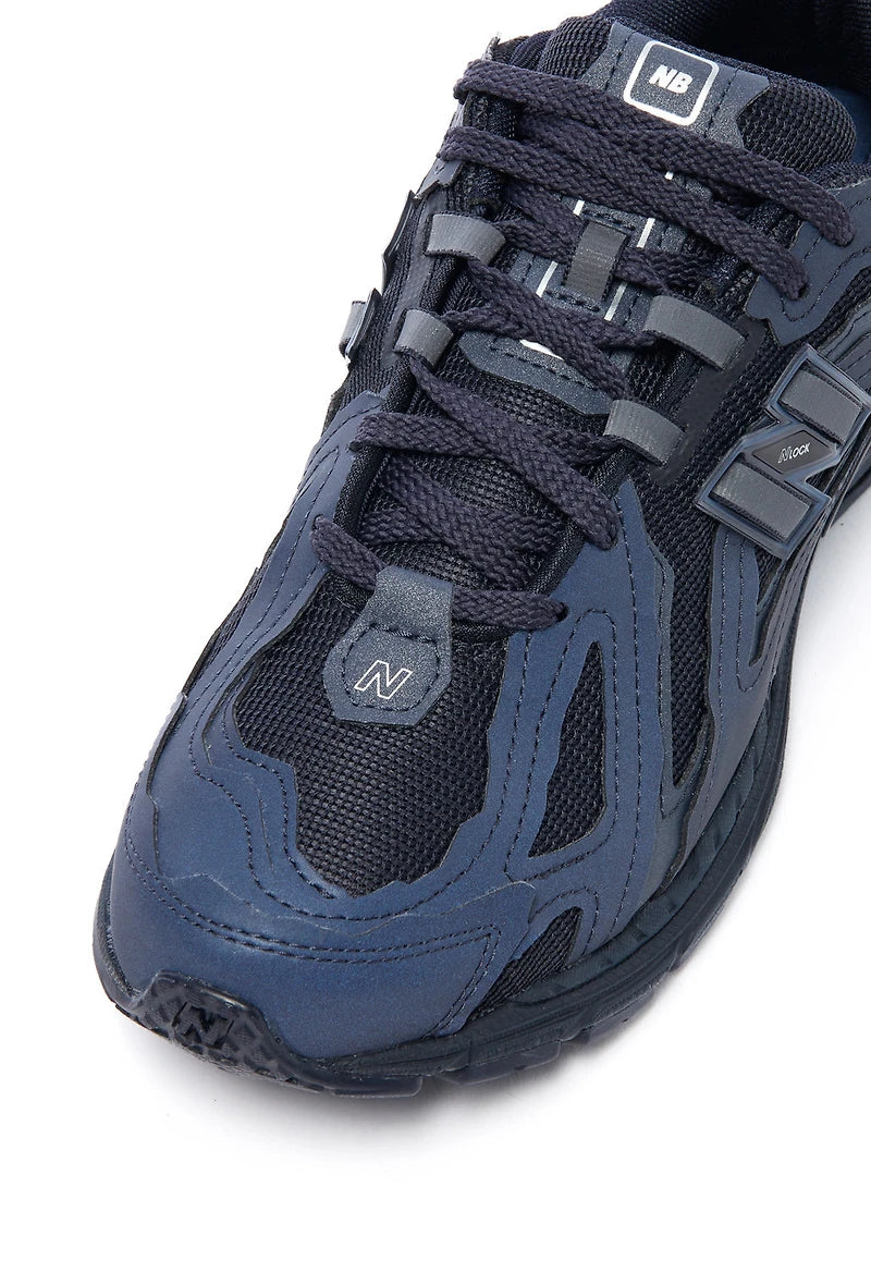 NB Eclipse Navy shoe upper close-up with laces, logo patch, and mesh panels