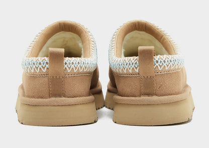 Back view of sand UG Tazz suede slippers with heel pull tab and light blue knit cuff