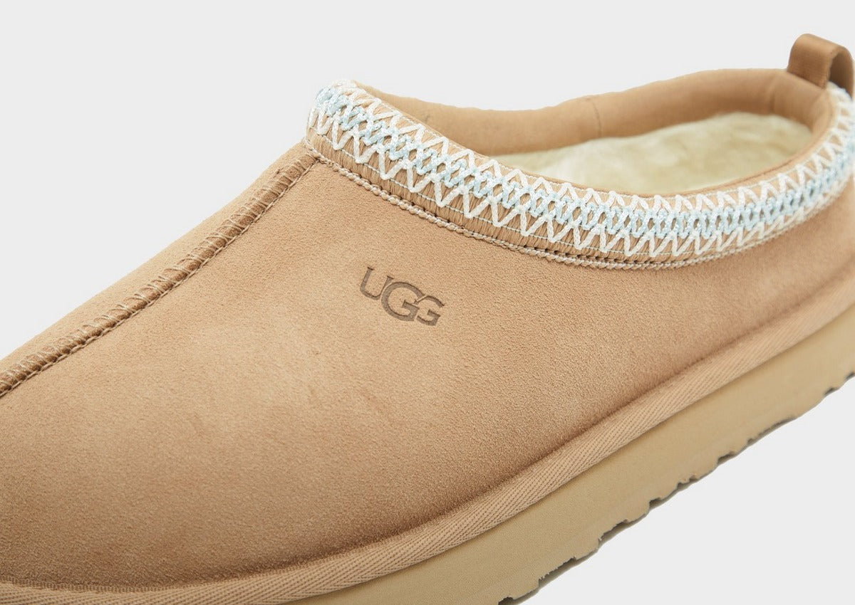 UG Tazz suede upper close-up with “UGG” logo, light blue knit edge, stitched seam