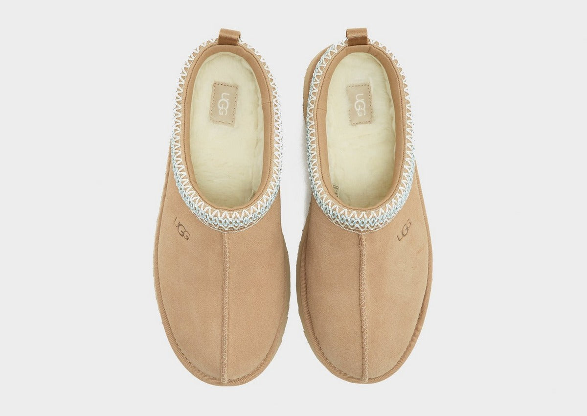 Pair of sand UG Tazz suede slippers with padded cream lining and light blue trim