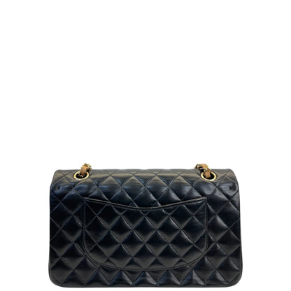 Quilted double flap handbag in dark leather with gold chain top handles and clasp