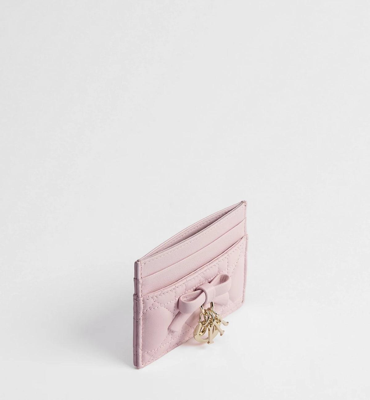 Pale pink card holder with ribbon bow, gold-tone clasp hardware