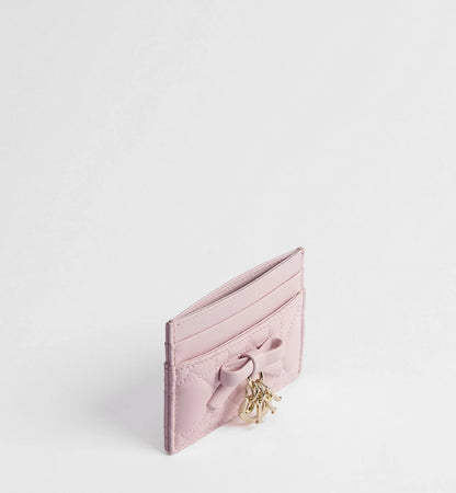 Pale pink card holder with ribbon bow, gold-tone clasp hardware