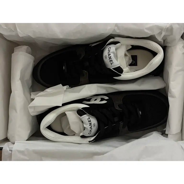 Black and white leather low trainers in box, CHANEL logo on tongue label