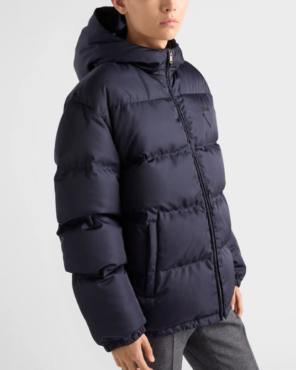 Close-up hooded down jacket in dark navy: quilted baffles, front zip, sleeve cuffs.
