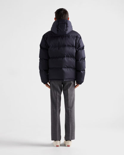 Back view hooded puffer jacket in dark navy, horizontal baffle quilting and hood.