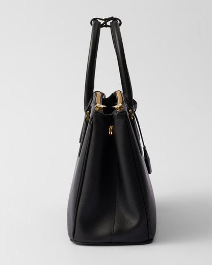 Side view of black Galleria medium Saffiano bag with structured top handles