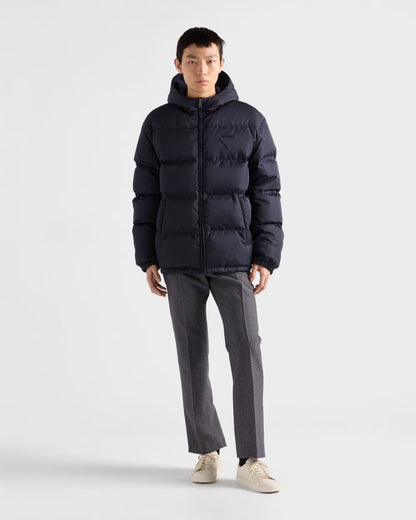 Hooded down jacket in dark navy, full-length front zip and side pocket openings visible.