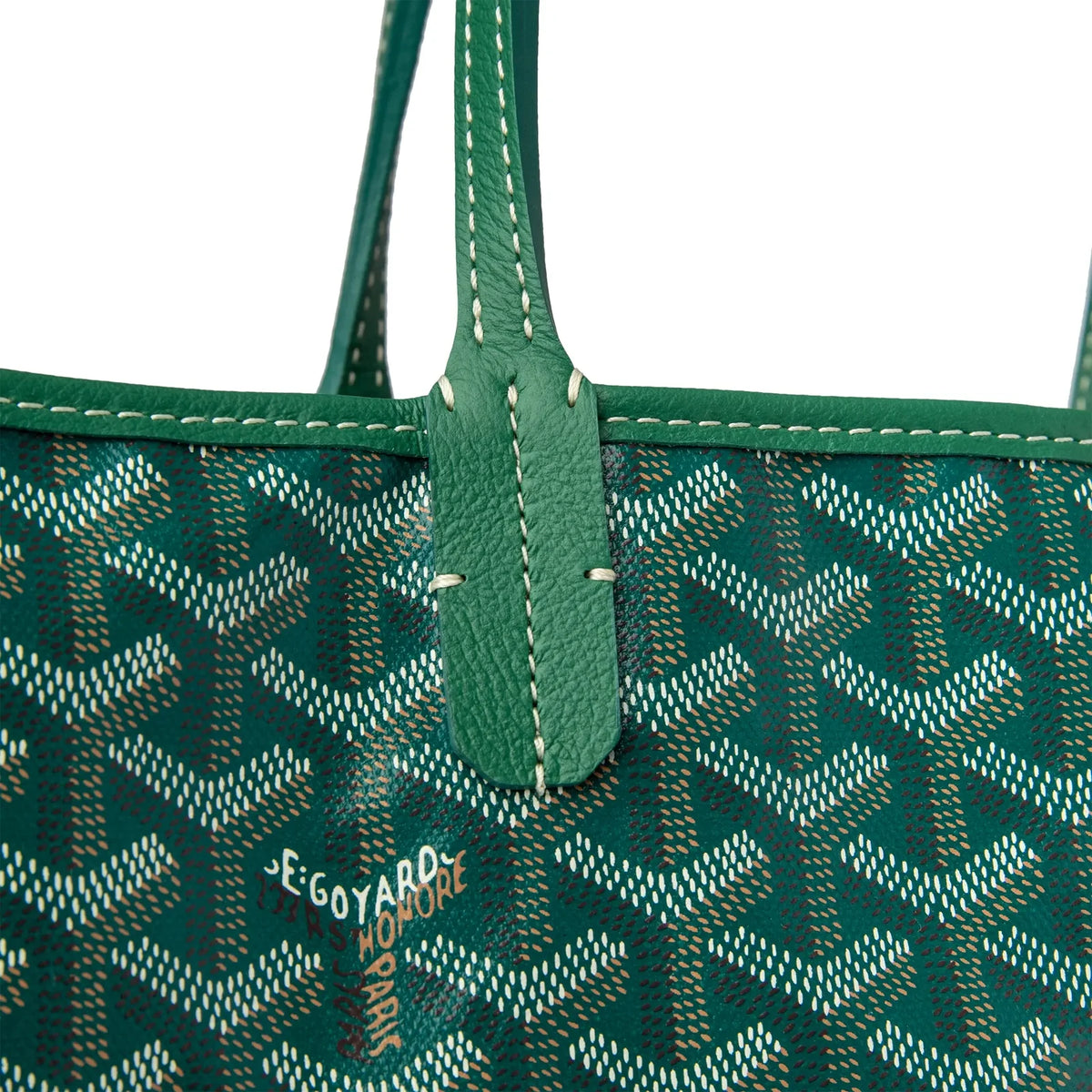 Green tote bag handle and stitched leather trim on a repeating logo pattern