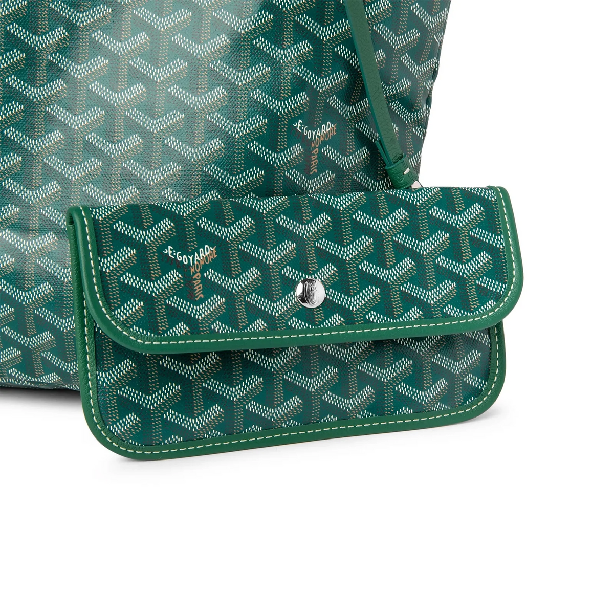 Green front flap pocket detail on a patterned tote bag with snap closure