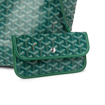 Green front flap pocket detail on a patterned tote bag with snap closure