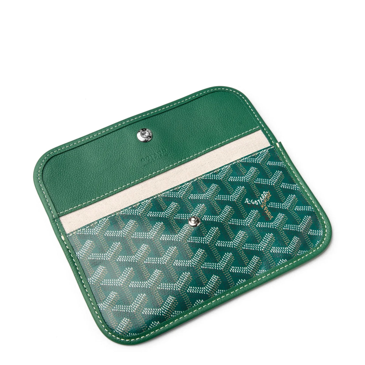 Green fold-over clutch/cover panel with snap and cream stripe detail on tote