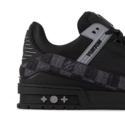 Close-up LV Trainer sneaker: cushioned collar, logo patch and sole