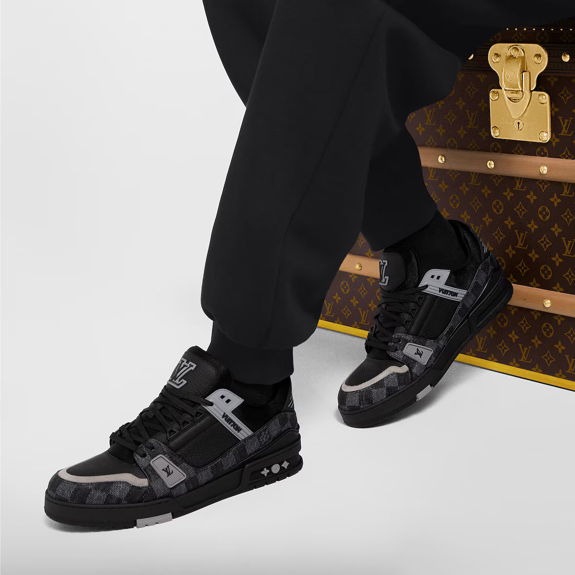 LV Trainer black sneakers on feet with chunky sole and logo straps