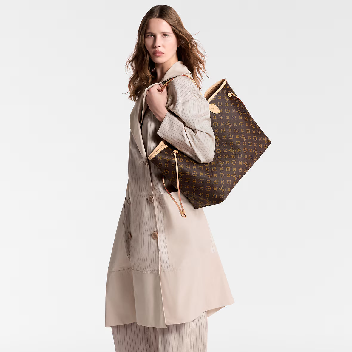 Neverfull GM tote on shoulder view, monogram canvas with tan leather straps and trim