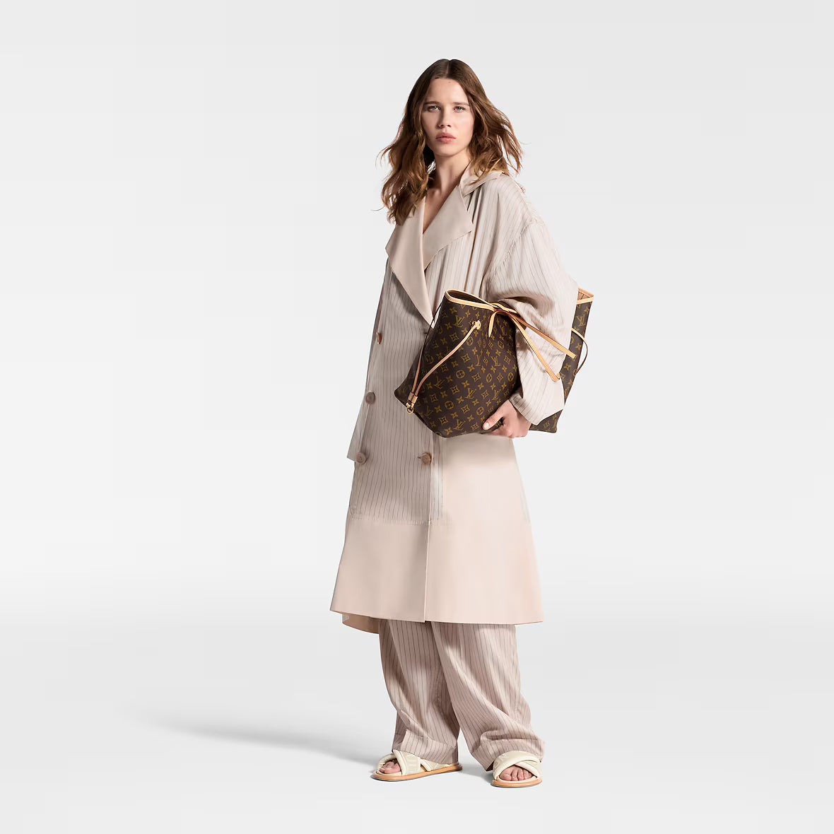 Louis Vuitton Neverfull GM tote held at side, monogram canvas with tan leather trim