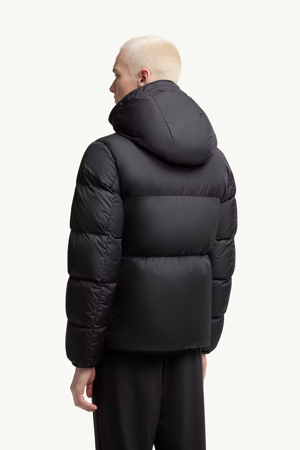 Black short down jacket back view, hooded padded design with stitched baffles
