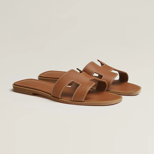 Oran sandal in tan leather with H-style straps and flat sole